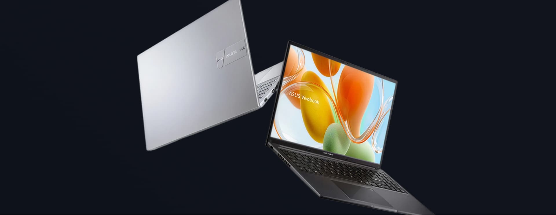 Two sleek laptops against a dark background; one open with a colorful screen and one closed showing a silver finish.